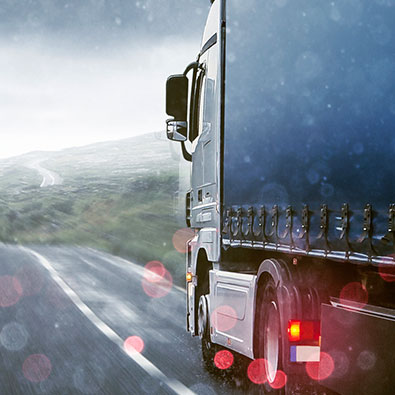 picture of semi-truck in rain on distorted road